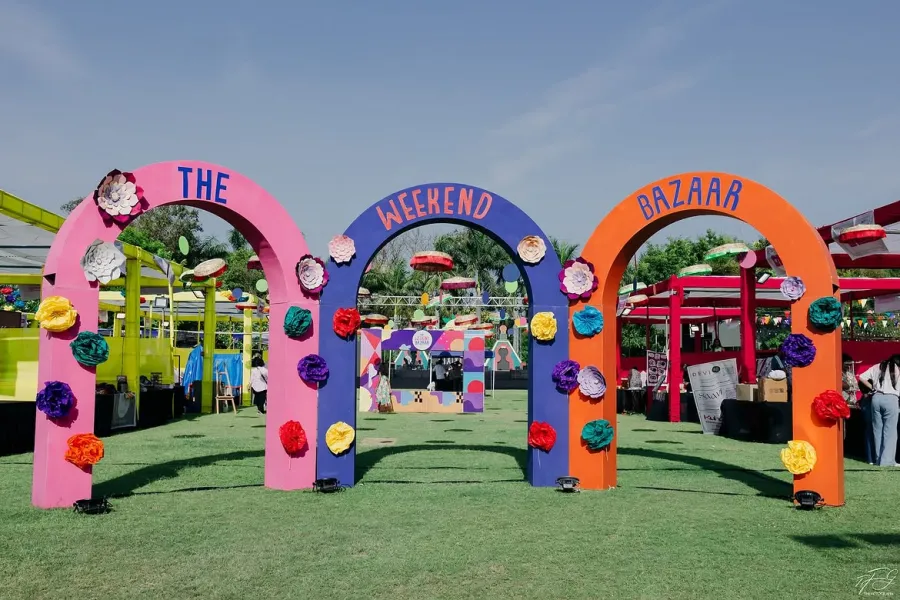 Bright arched entrance gates spelling out The Weekend Bazaar