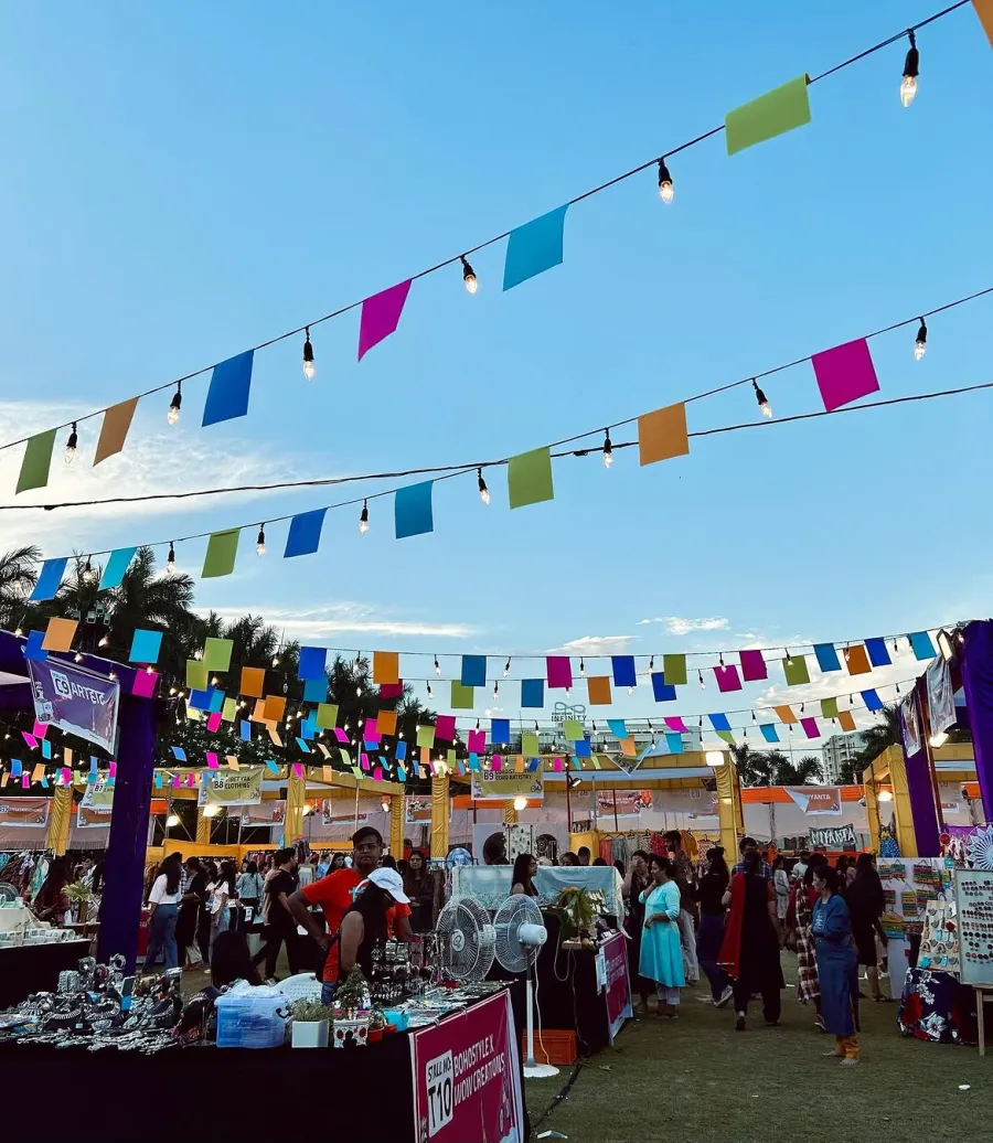 Rows of stalls under strings of colourful bunting and festoon lights
