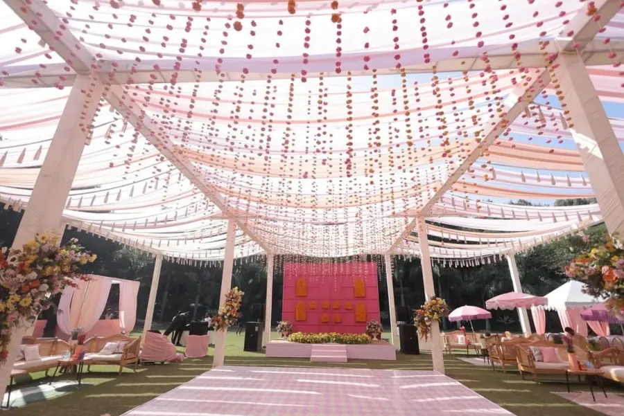 Canopy of pink floral strings over the guest pathway