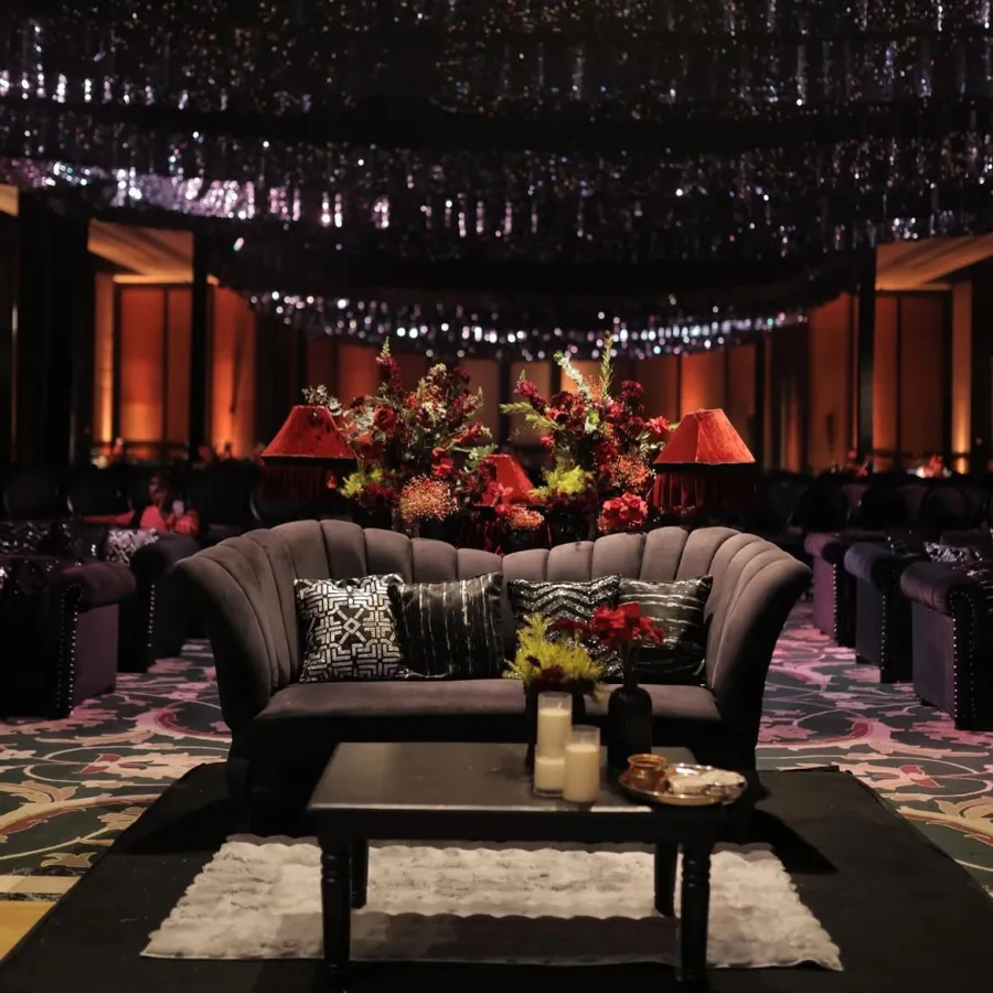 Evening lounge under a hanging installation, richly lit