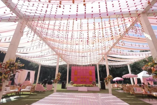 Canopy of pink floral strings over the guest pathway
