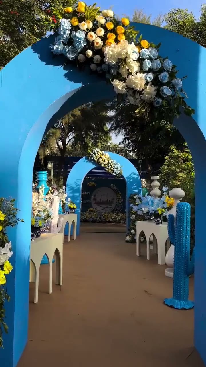 A blue and white couture-inspired garden setting with sculptural florals
